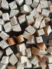 Cubed bread on a black tray