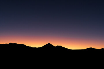 First moments of sunrise, with the Licancabur volcano silhouette in the center of the image.