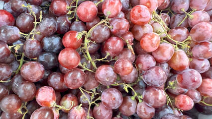 Close up of raw organic sweet red grapes background, wine grapes texture, Healthy fruits Red wine grapes background, top view