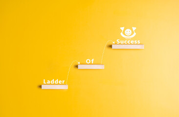 Wooden blocks are arranged as steps with word Ladder of Success. Stairs or paths of a challenge to...