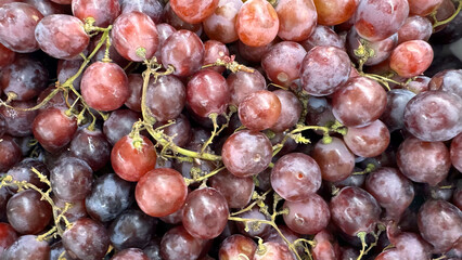 Close up of raw organic sweet red grapes background, wine grapes texture, Healthy fruits Red wine grapes background, top view