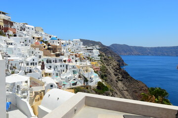 Fototapeta na wymiar SANTORINI,GREECE-June 20 2023: Oia village, the most picturesque village on Santorini island, a famous touristic resort in the Cyclades islands, Aegean sea, Greece, Europe. This was on a hot sunny day
