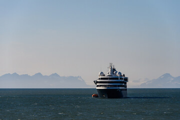Large cruise ship in the calm ocean outside Longyearbyen, Svalbard in the arctic early in the...
