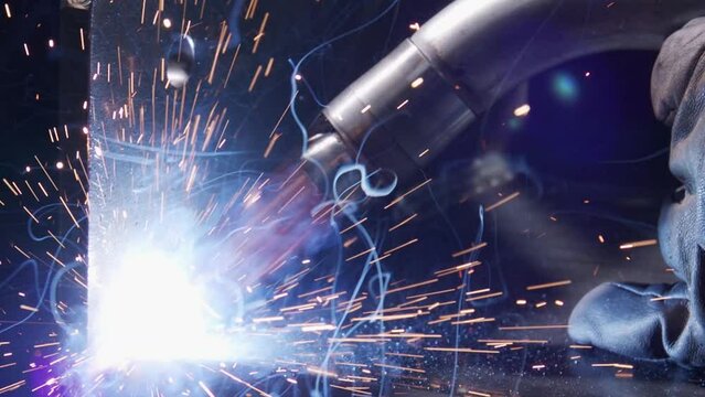 Closeup footage of work metal inert gas welding or metal plate carbon steels welding to structure