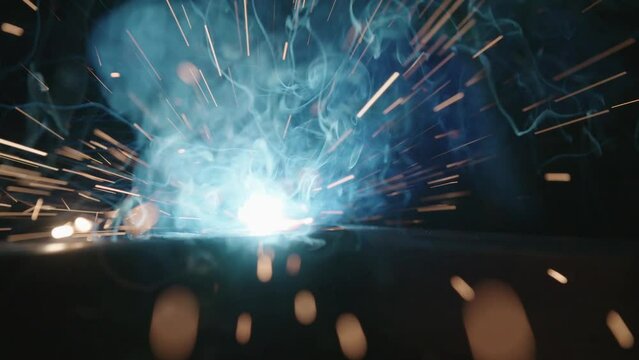 Closeup footage of the metal inert gas welding or metal plate carbon steels welding to structure