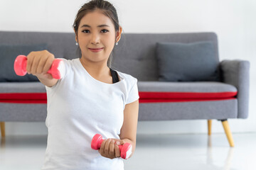 Young Woman Fitness with Dumbbell in Living Room at Home