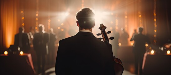 String orchestra cellist at wedding ceremony, back view