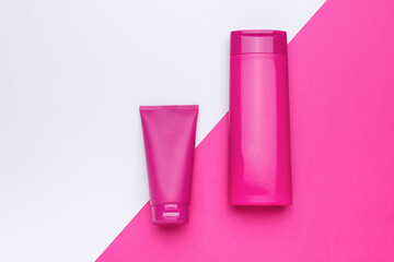 Bright bottles for cosmetics on a two-tone background.