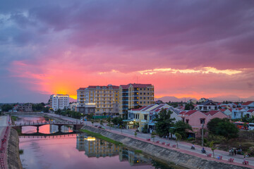 A dramatic sunset over a river running through the city of Hoi An in Vietnam