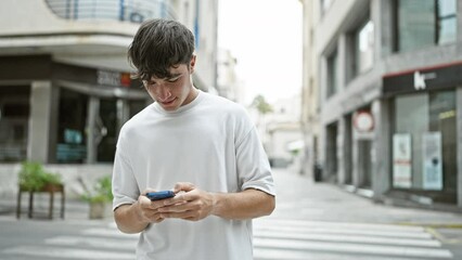 Young hispanic teenager, exuberantly celebrating his street win on his smartphone, while cruising around town. tech-savvy guy, happiness radiating, engaging in an exciting online conversation.