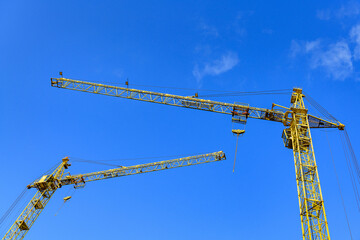 Construction site background. Construction cranes against the sky..
