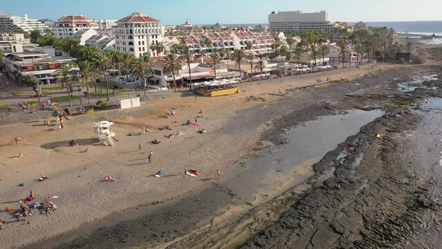 Aerial 4K video from drone to de Tenerife and beachs Adeje Playa de las Americas, Playa Honda,Playa de Troya, Playa de El Bobo.In the background Tenerife at sunset. Tenerife, Canary islands, Spain 