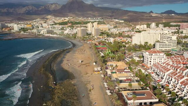 Aerial 4K video from drone to de Tenerife and beachs Adeje Playa de las Americas, Playa Honda,Playa de Troya, Playa de El Bobo.In the background Tenerife at sunset. Tenerife, Canary islands, Spain 