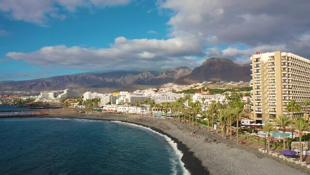 Aerial 4K video from drone to de Tenerife and beachs Adeje Playa de las Americas, Playa Honda,Playa de Troya, Playa de El Bobo.In the background Tenerife at sunset. Tenerife, Canary islands, Spain 