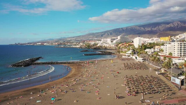 Aerial 4K video from drone to de Tenerife and beachs Adeje Playa de las Americas, Playa Honda,Playa de Troya, Playa de El Bobo.In the background Tenerife at sunset. Tenerife, Canary islands, Spain 