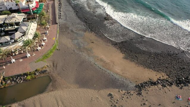 Aerial 4K video from drone to de Tenerife and beachs Adeje Playa de las Americas, Playa Honda,Playa de Troya, Playa de El Bobo.In the background Tenerife at sunset. Tenerife, Canary islands, Spain 