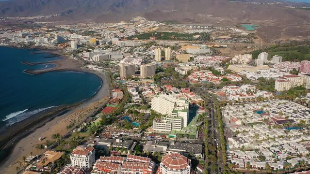 Aerial 4K video from drone to de Tenerife and beachs Adeje Playa de las Americas, Playa Honda,Playa de Troya, Playa de El Bobo.In the background Tenerife at sunset. Tenerife, Canary islands, Spain 