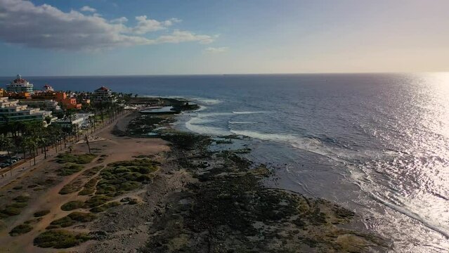 Aerial 4K video from drone to de Tenerife and beachs Adeje Playa de las Americas, Playa Honda,Playa de Troya, Playa de El Bobo.In the background Tenerife at sunset. Tenerife, Canary islands, Spain 