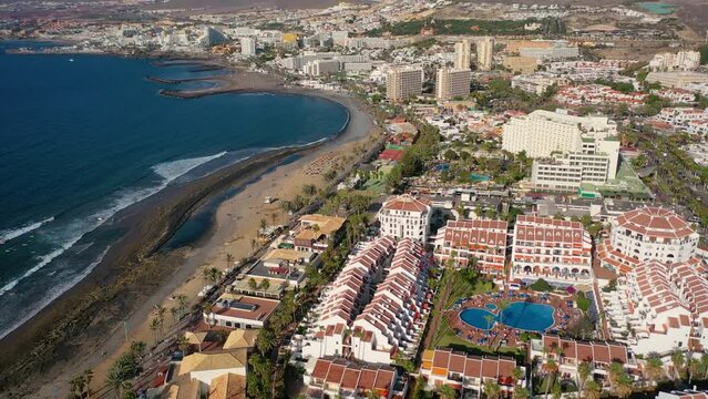 Aerial 4K video from drone to de Tenerife and beachs Adeje Playa de las Americas, Playa Honda,Playa de Troya, Playa de El Bobo.In the background Tenerife at sunset. Tenerife, Canary islands, Spain 