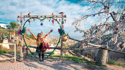 Fototapeta premium Happy traveler woman enjoying panoramic view of Cappadocia landscape with fairy rock formation, Uchisar, Goreme- Travel, tour tourism, activity in Turkey