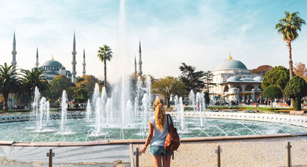 Fototapeta premium Female tourist travelling in Turkey- Istanbul with blue mosque and fountain- Travel and vacation in Turkey concept- Europe and Asia