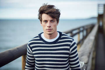 Portrait of a young French man wearing a striped sailor sweater - obrazy, fototapety, plakaty
