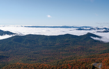 mountains in the fog covered landscape with fall color