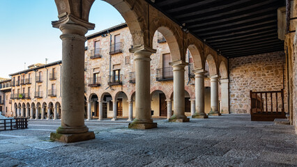 Portico with stone arches and columns in the main square of the medieval city of Siguenza.