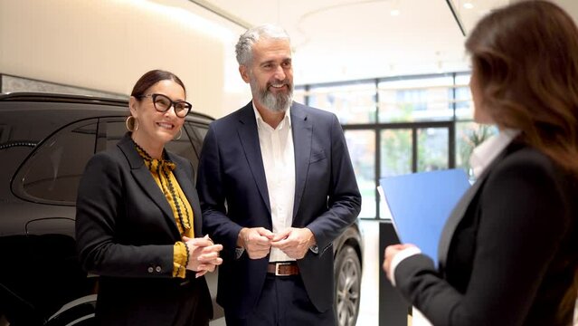 Excited couple buying a new car