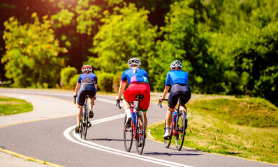 Fototapeta premium Cyclists ride on the bike path in the city Park 