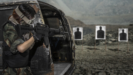 Military soldier shooter aiming ar assault rifle weapon at outdoor academy shooting range
