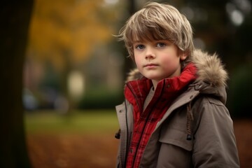 Portrait of a cute little boy in the autumn park. Outdoor shot.