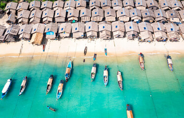 Aerial view of Koh Surin Marine National Park. Traditional long-tail boats and houses of Moken tribe Village or Sea Gypsies and tropical waters of Surin Islands in Thailand, Phang Nga.