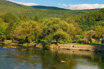 Fototapeta na wymiar The River Una as it passes through Kulen Vakuf village in the Una National Park. Una-Sana Canton, Federation of Bosnia and Herzegovina. Early September
