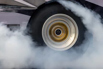Papier Peint photo Lavable Fumée Car burnout wheels tire with white smoke,Car wheel burnout with smoke from the spinning tyre, Drag car wheel burns tires preparation for the race.