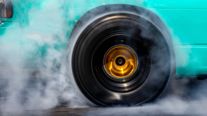 Car burnout wheels tire with white smoke,Car wheel burnout with smoke from the spinning tyre, Drag...