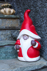 Cute Santa Claus, Father Christmas figure at door steps.