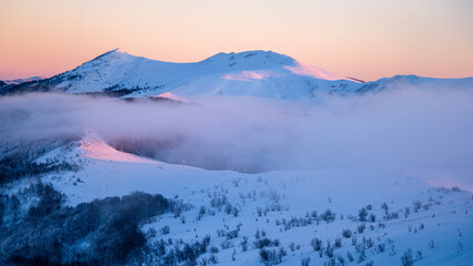 Beautiful winter mountain landscape. Moody sunset seen from the Mount Smerek in the Bieszczady...