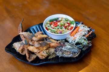 Pla Kapong Tod Nam Pla - Deep fried sea brass with fish sauce, serve with spicy mango salad and seafood sauce