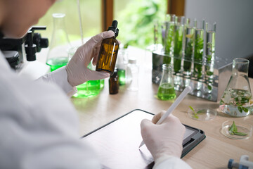 Young Scientist woman, laboratory and test tube with plants, research and analysis of leaves for...