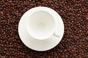 Top view of empty white coffee cup place on surface many roasted coffee beans background.