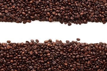 Top view of roasted coffee beans texture background on flat lay in horizontal with white free space...