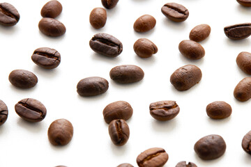 Top view Roasted coffee beans scattered isolated on a white background.