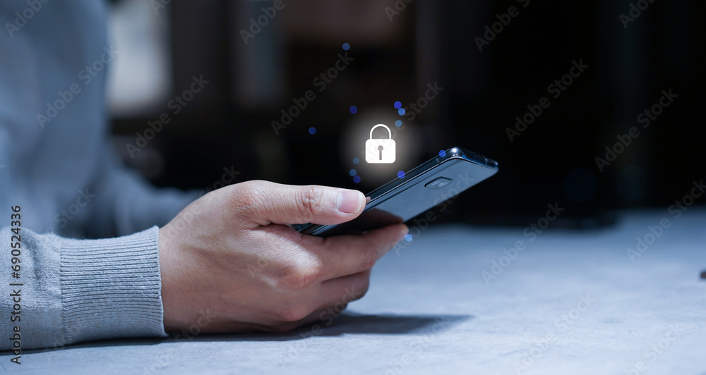 Wall mural close up young man hand use smartphone with virtual reality interface locked for protection data in 