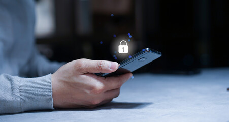 close up young man hand use smartphone with virtual reality interface locked for protection data in home  for cyber security and digital authentication concept