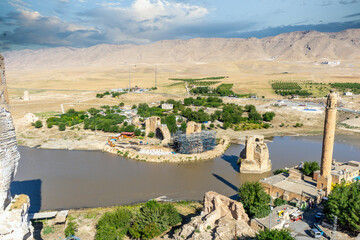 Fototapeta na wymiar Hasankeyf ancient city. Hasankeyf, which has a history of 12,000 years, was submerged under the dam waters of the Tigris (Dicle) River with its historical bridges and structures. Batman, TURKEY