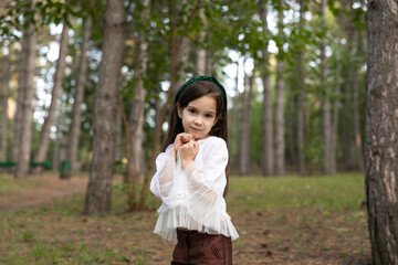 Horizontal view of a cute preschool age girl posing pretty at camera.