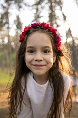 Closeup portrait of a cute little girl smiling and looking at camera, wear headbands.