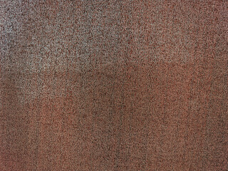 A close-up of a brown textured surface with a rough, grainy appearance. The texture is uniform and covers the entire image.