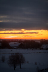 Rural landscape with wind turbine on cold winter morning with sunrise outside Lund Sweden